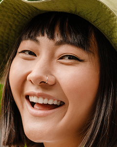 young asian woman wearing hat smiling while walkin 2025 02 14 08 54 25 utc 1